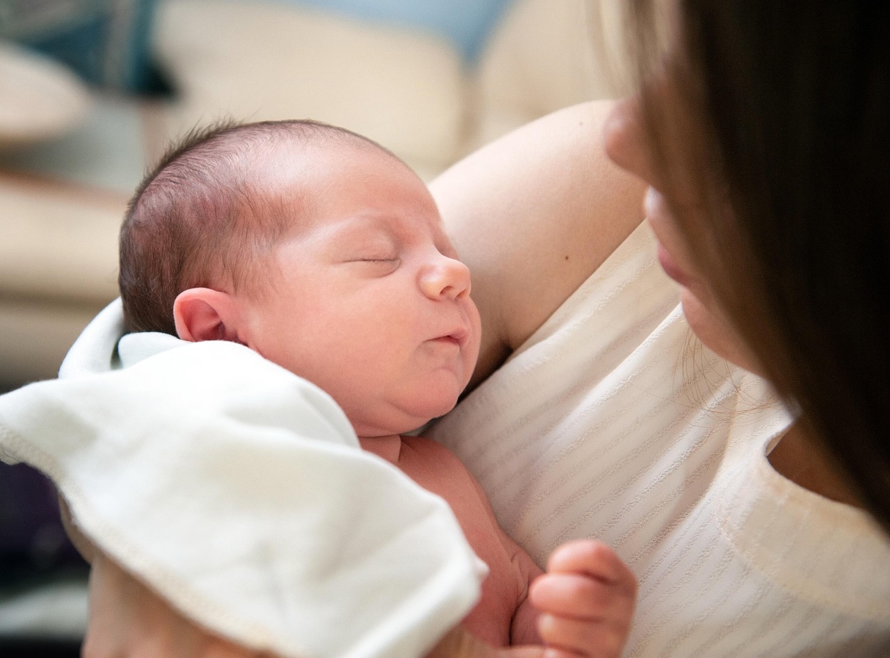Little Cedars infant room educator caring for baby